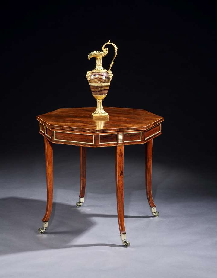 A George III brass mounted and parcel gilt rosewood centre table
